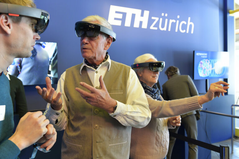 ETH Alumni engage with new HoloLens technology to study molecules for drug design.