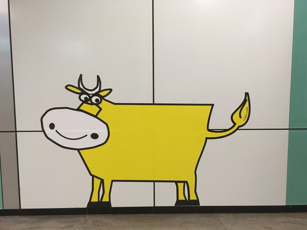 Cartoon of a cow in the MRT (Mass Rapid Transport) of Singapore as an advertisement for Moove Media.
