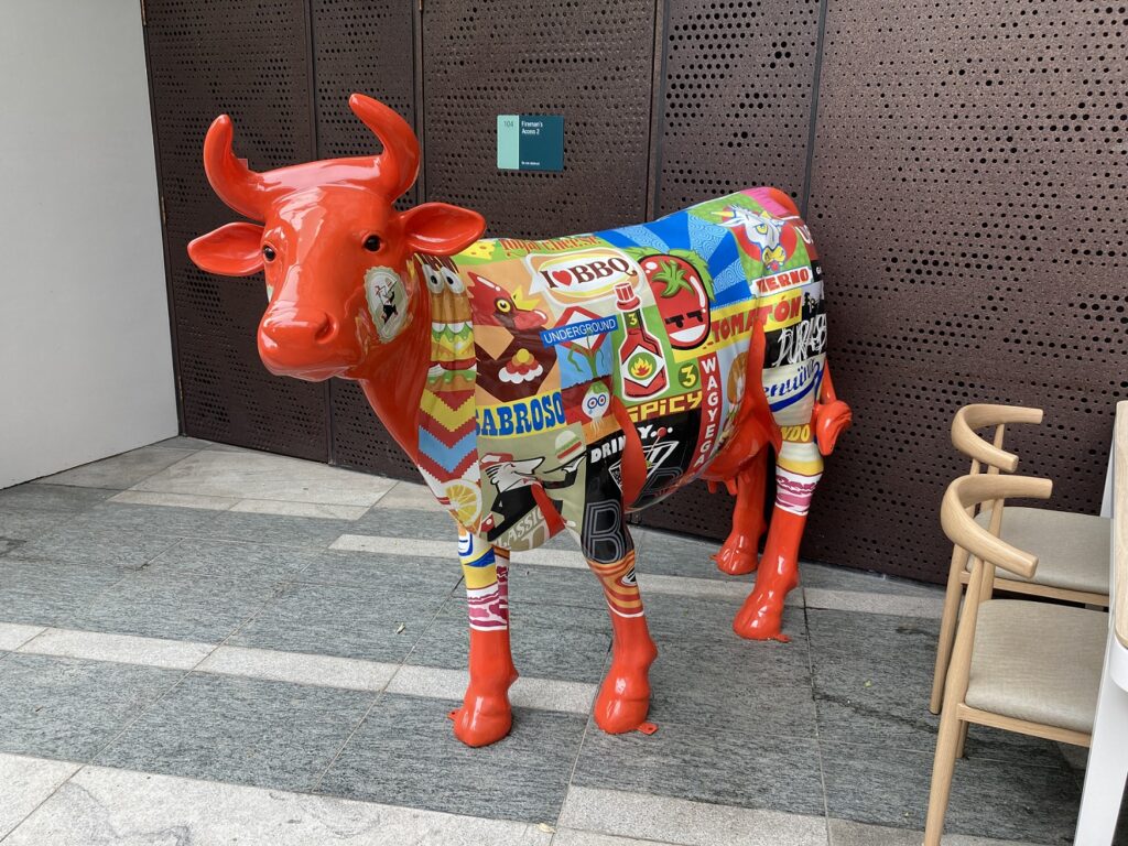 Red cow advertising the Spanish Restaurant Pura Brasa.