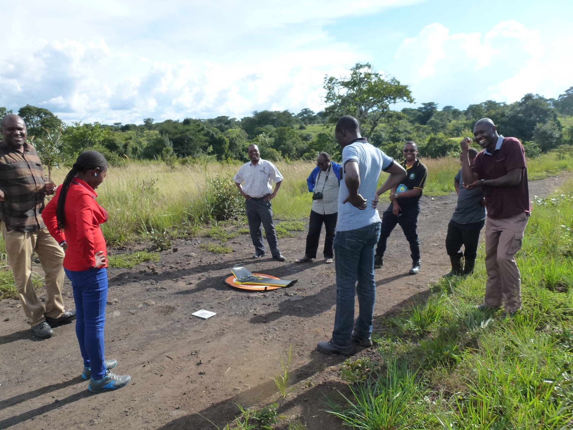 Students from University of Zambia gathering around the drone before the first flight back in 2018