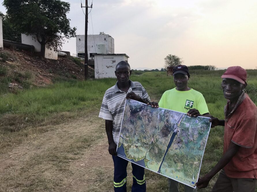 Farmers holding a printed aerial image
